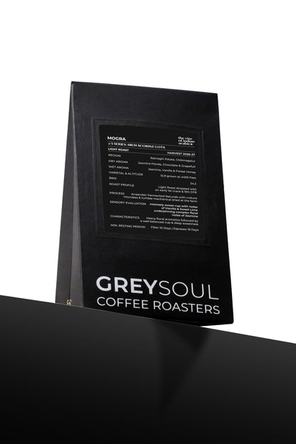 Black coffee bag with text detailing coffee flavor profile and brand name on a white background grey soul coffee mogra